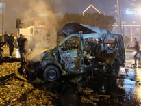 A damaged vehicle is seen after a blast outside a football stadium in Istanbul