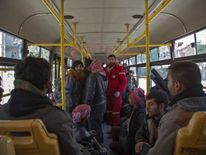 People gather to be evacuated from a rebel-held sector of eastern Aleppo