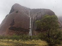 Waterfalls run down Uluru. Pic: @BiancaH80 and @waginski