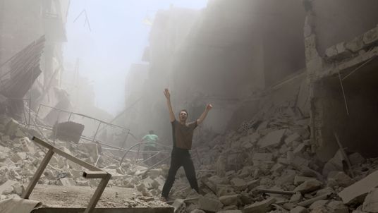 A man cries for help after a rocket attack in eastern Aleppo