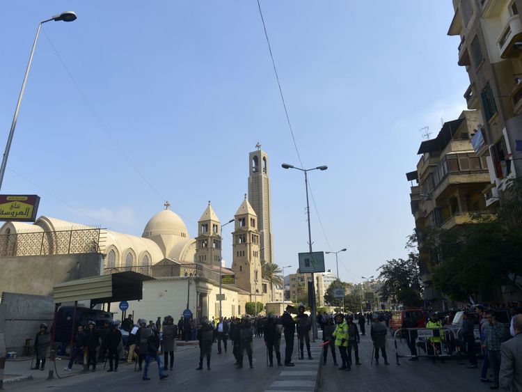 Police and onlookers after the blast at the Coptic cathedral in Cairo