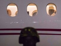 Mr Jammeh looks through the window of his plane as he leaves his country