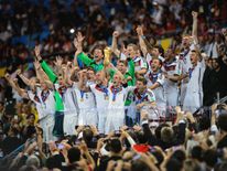 Philipp Lahm of Germany lifts the World Cup trophy with teammates after defeating Argentina 1-0 during the 2014 FIFA World Cup final in Brazil