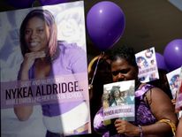 People attend a vigil for Nykea Aldridge, who was killed by a stray bullet