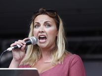 Welsh singer Charlotte Church speaks to protesters following a march against the British government&#39;s spending cuts 
