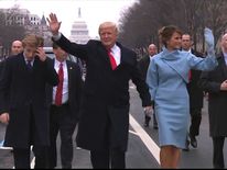 Donald Trump walks with wife Melania and son Barron during the parade