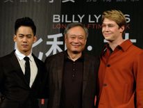 Director Ang Lee with actors Mason Lee (L) and Joe Alwyn