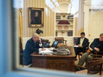 President Donald Trump speaks on the phone with Australian Prime Minister Malcolm Turnbull in the Oval Office of the White House, January 28, 2017 in Washington, DC. Also pictured at right, National Security Advisor Michael Flynn and White House Chief Strategist Steve Bannon. On Saturday, President Trump is making several phone calls with world leaders from Japan, Germany, Russia, France and Australia