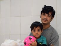 Bangladeshi man Abul Bajandar, widely known as 'Tree Man', with his daughter in hospital in Dhaka after surgery removed many of the warts on his body