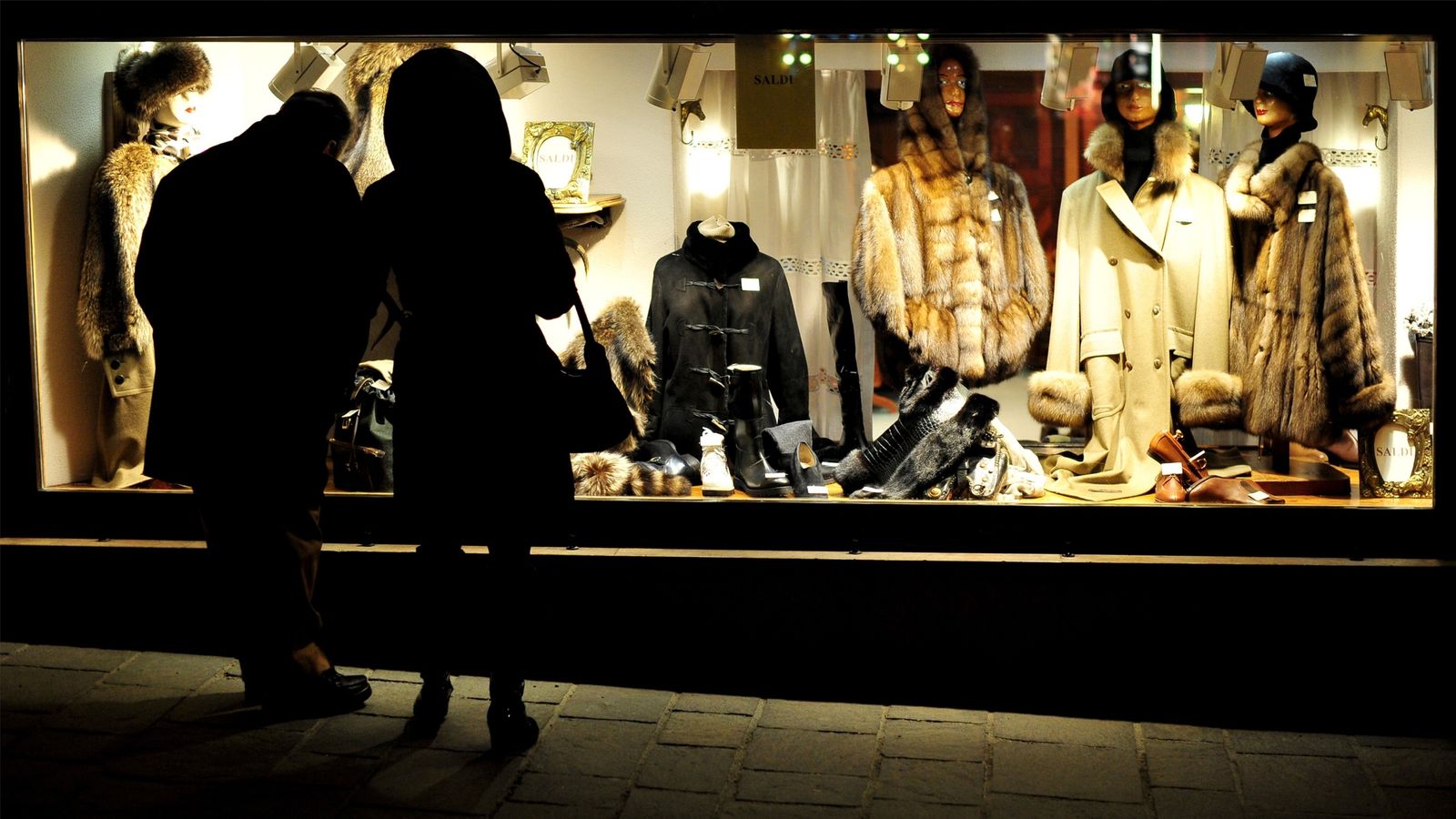 People pass in front of luxury shops in Cortina d&#39;Ampezzo on January 15, 2012..Italian Tax authorities have launched a high-profile raid on December 30 , 2011 on the exclusive ski resort of Cortina d&#39;Ampezzo with 80 tax inspectors who checked restaurants, bars, luxury stores and the owners of luxury cars leading to a massive 400-percent increase in declared turnover from the resort&#39;s businesses compared to the previous season. Out of 133 luxury cars checked, 42 owners had declared incomes of les