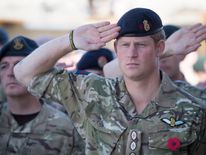 Prince Harry joins British troops and service personal remaining in Afghanistan and also International Security Assistance Force (ISAF) personnel and civilians as they gather for a Remembrance Sunday service at Kandahar Airfield November 9, 2014 in Kandahar, Afghanistan