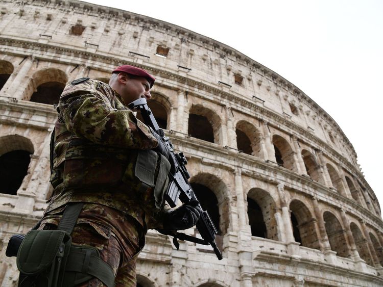 A soldier patrols near the ancient Colosseum in Rome ahead of an EU summit