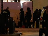 Police secure a side street as others conduct an investigation on the Champs Elysees Avenue