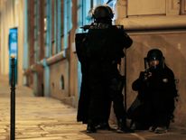 Armed police officers block the access of a street near the Champs-Elysees 