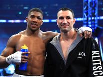 Anthony Joshua stands with Wladimir Klitschko following the IBF, WBA and IBO Heavyweight World Title bout