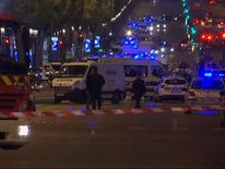 Emergency services respond after a policeman is shoot dead in Paris