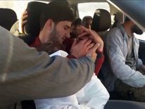 Abdel Hameed al-Youssef cradles his dead twins after the suspected chemical attack