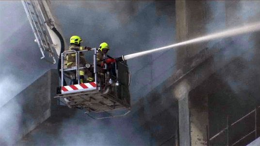 Firefighters battle the blaze at a Dubai residential complex that is under construction