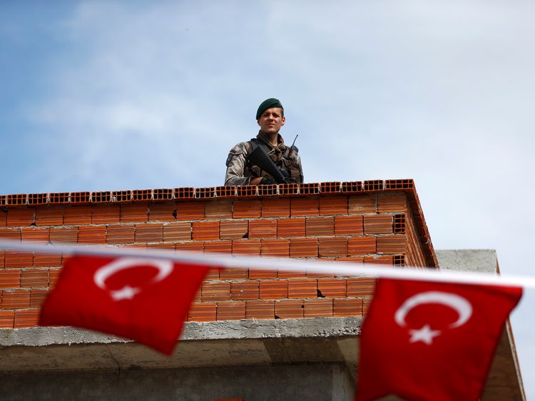 A security officer on a roof near a polling station in the Aegean port city of Izmir