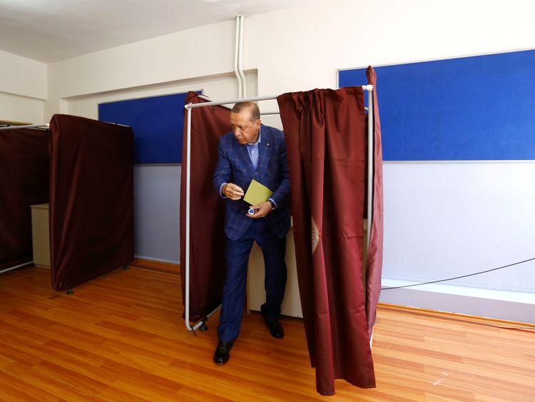 Turkish President Recep Tayyip Erdogan leaves a voting booth in Istanbul