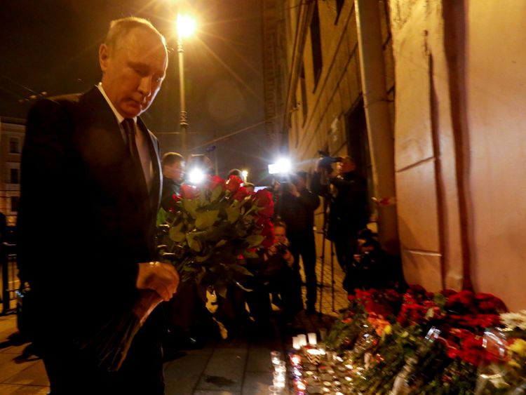 Vladimir Putin lays flowers outside Technology Institute station