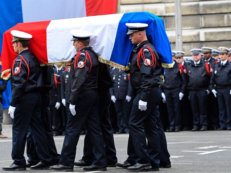 Officers carry Xavier Jugele's coffin during the ceremony