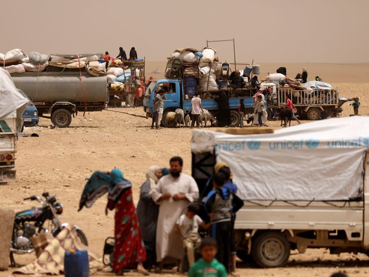 Refugees who fled from Raqqa gather at a camp in Ain Issa