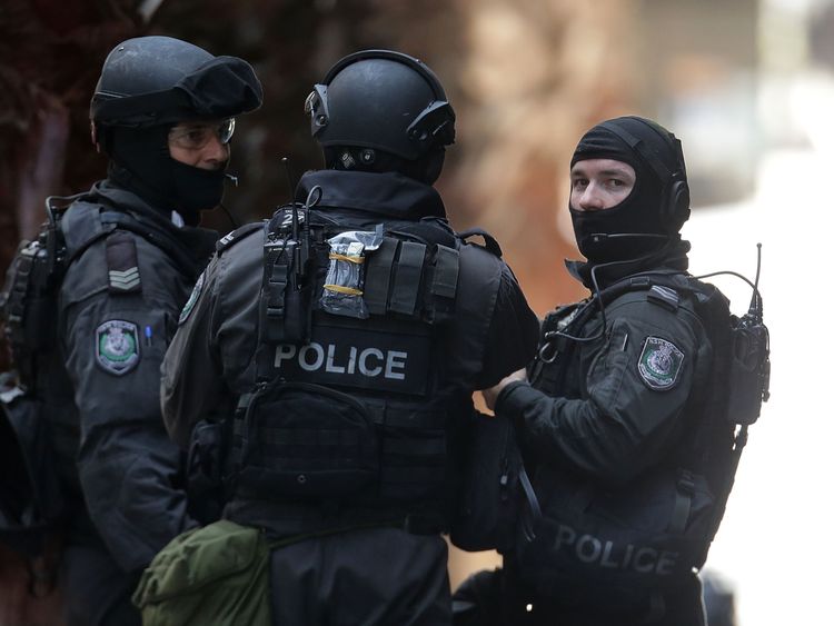 Armed policeman talk on Phillip St close to Martin Place on December 15, 2014 in Sydney, Australia