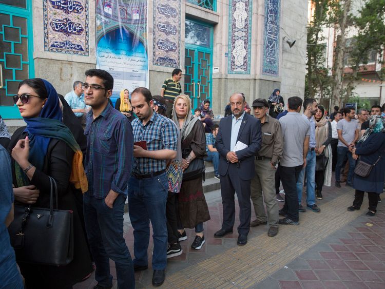 Voters queue in Tehran to vote in the election