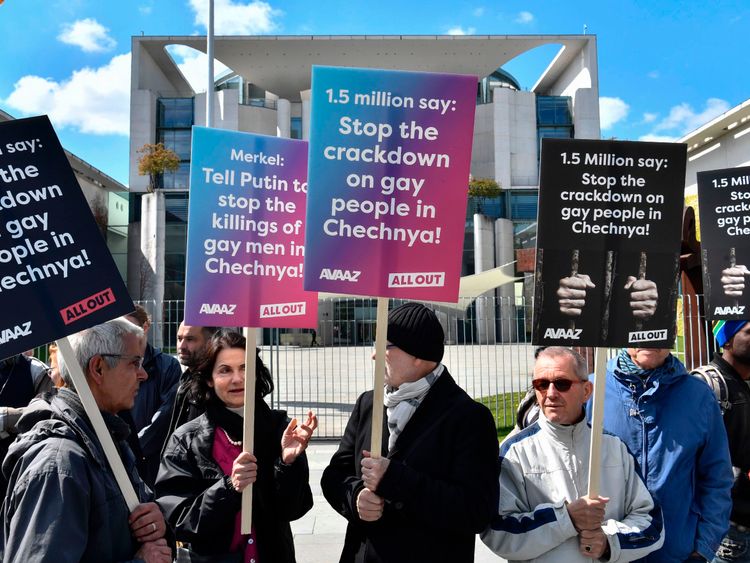 Activists display placards in front of the Chancellery in Berlin on April 30, 2017, during a demonstration calling on Russian President to put an end to the persecution of gay men in Chechnya