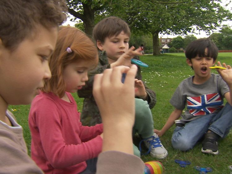 Children play with fidget spinners