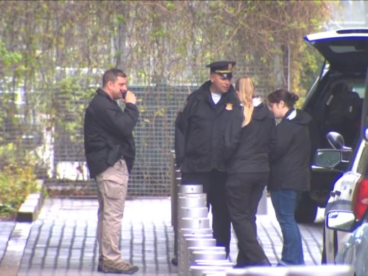 Forensic officers outside the building
