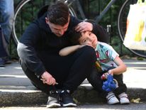 A man comforts a boy near the Grenfell Tower block fire