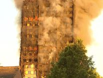 Apartment block on fire in West London in the day light.