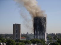 Smoke billows from Grenfell Tower as firefighters attempt to control a huge blaze