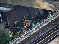 Fire fighters gather near the building