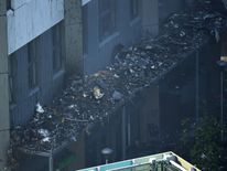 Debris on a roof after a huge fire engulfed the 24 story Grenfell Tower in Latimer Road, West London