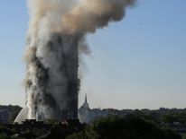 Flames and smoke billow from a tower block at Latimer Road in West London