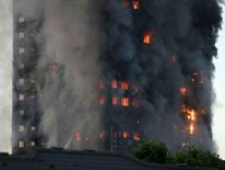 Flames and smoke billow from a tower block at Latimer Road in West London