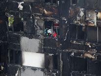 A firefighter examines the charred building