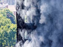 Smoke billows from a fire that has engulfed the 24-storey Grenfell Tower in west London