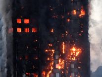 Flames and smoke engulf a tower block, in north Kensington, West London