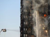 Flames and smoke billow from a tower block at Latimer Road in West London