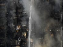 Flames and smoke billow from a tower block at Latimer Road in West London