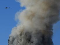 Flames and smoke billow from a tower block at Latimer Road in West London