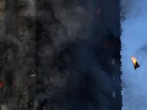 Flames and smoke billow from a tower block at Latimer Road in West London