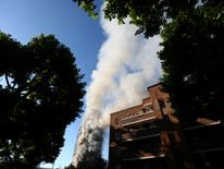 Smoke billows from the tower block