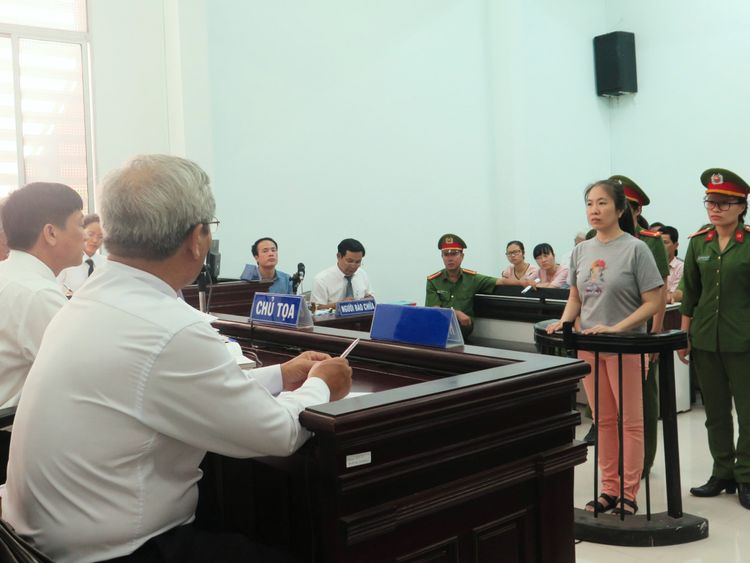 Vietnamese blogger Nguyen Ngoc Nhu Quynh (2nd R), also known as 'Mother Mushroom', stands trial