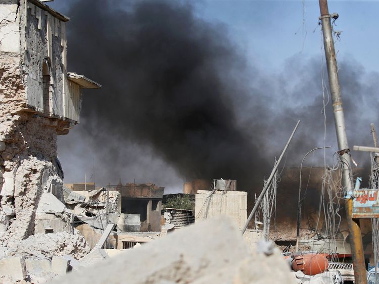 Smoke billows from the ruins of Grand al-Nuri Mosque after it was retaken by the Iraqi forces from the Islamic State militants at the Old City