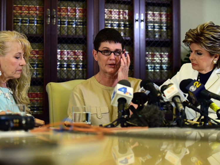 Beth Ferrier reacts while speaking seated between attorney Gloria Allred and Rebecca Lynn Neal